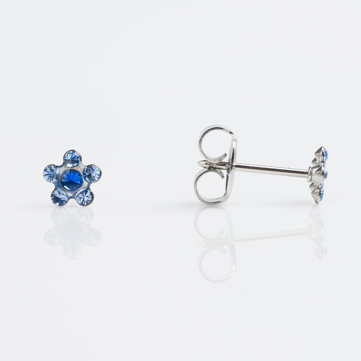S6399WSTX – Studex Sensitive Stainless Daisy Stud Light Sapphire Sapphire  Earrings